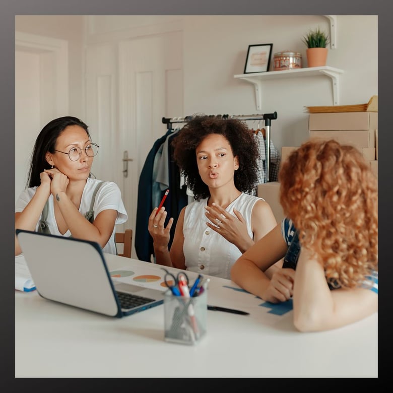 Entrepreneurs at a desk, having a collaboration meeting.